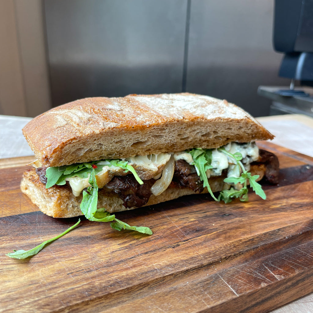 Steak sandwich with peppercorn butter, fried onions & blue cheese by Barry Horne