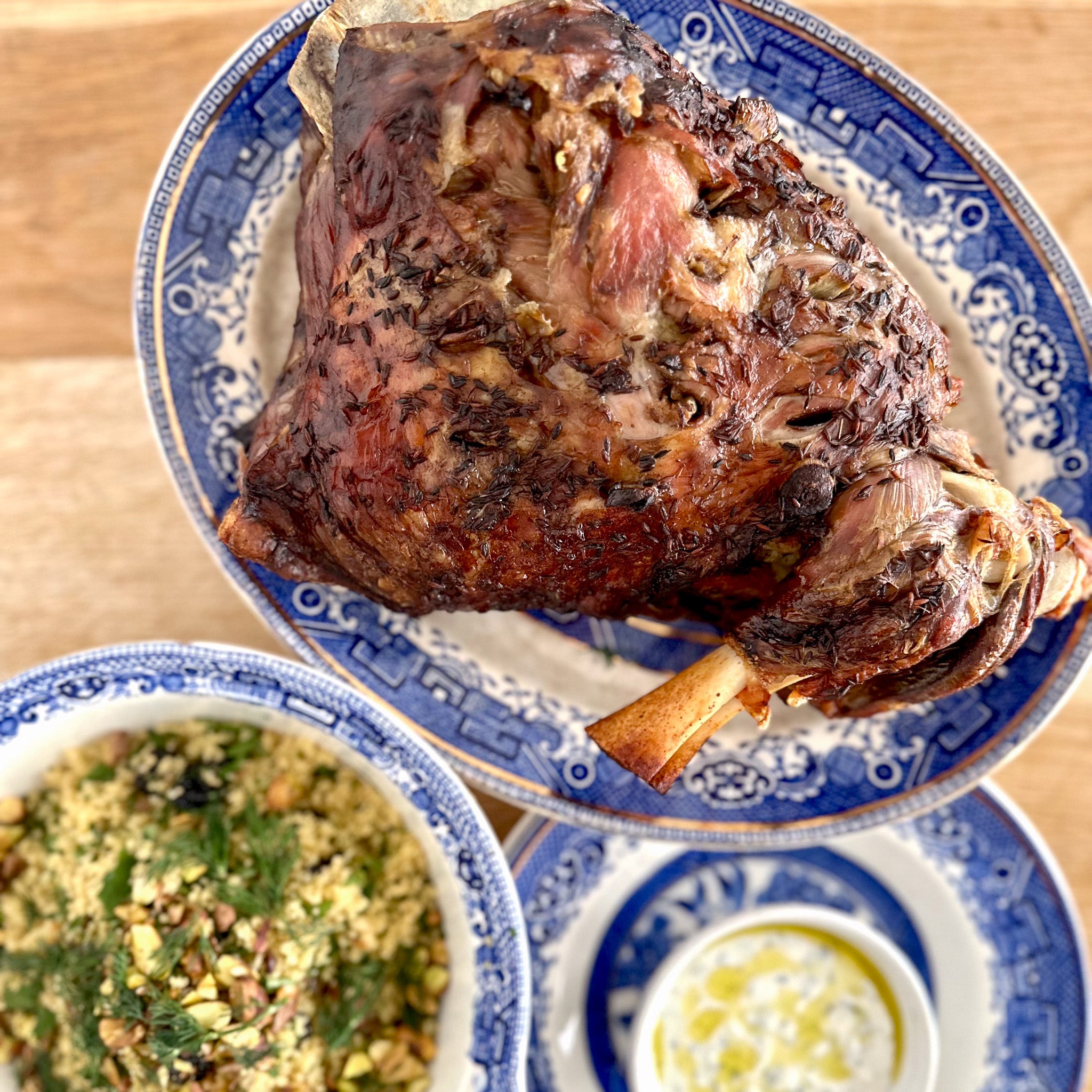 Slowcooked lamb shoulder with orange & pistachio couscous & minted yo