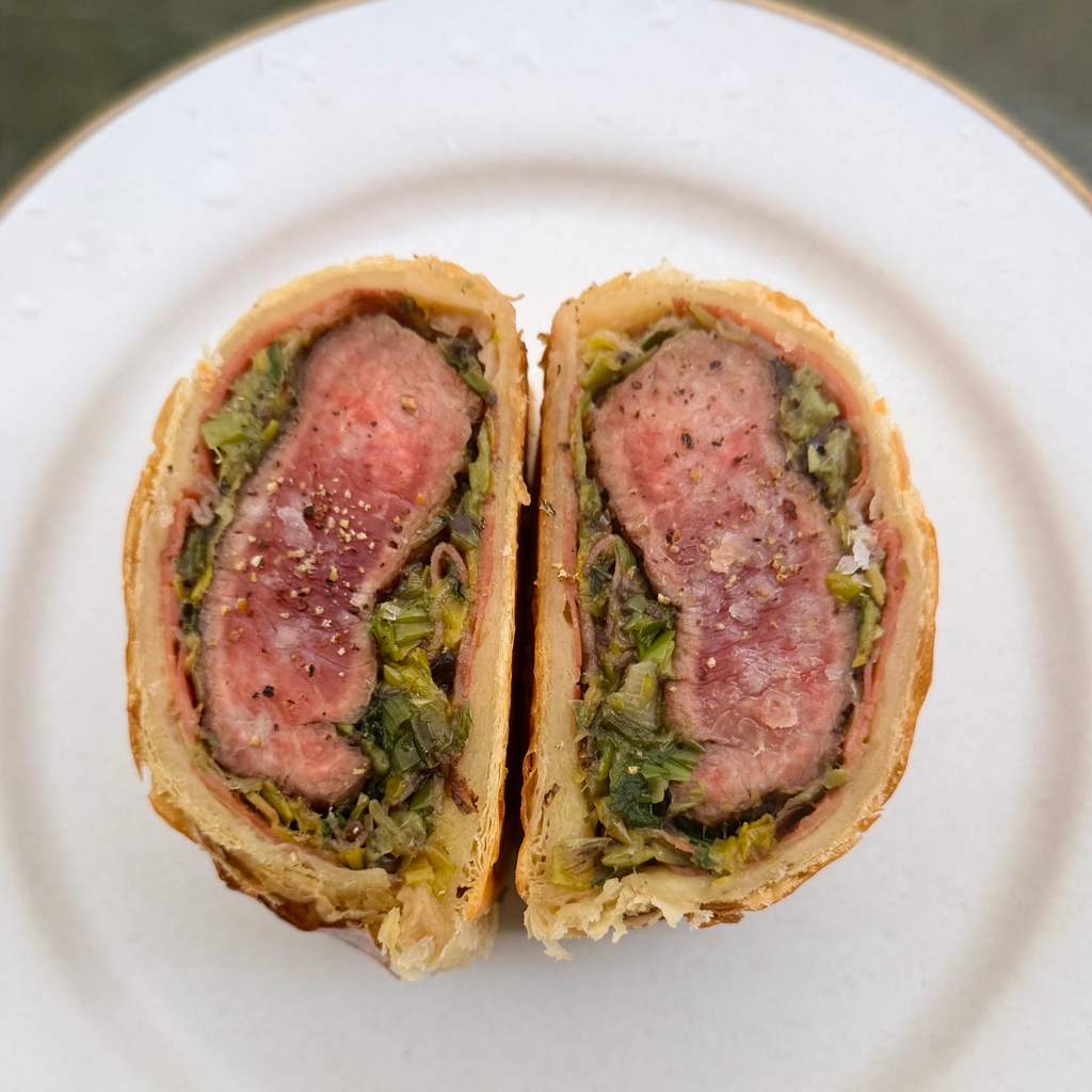 Lamb Wellington with Leek, Rosemary, Black olive & Bitter Leaf Salad by Matt Burgess